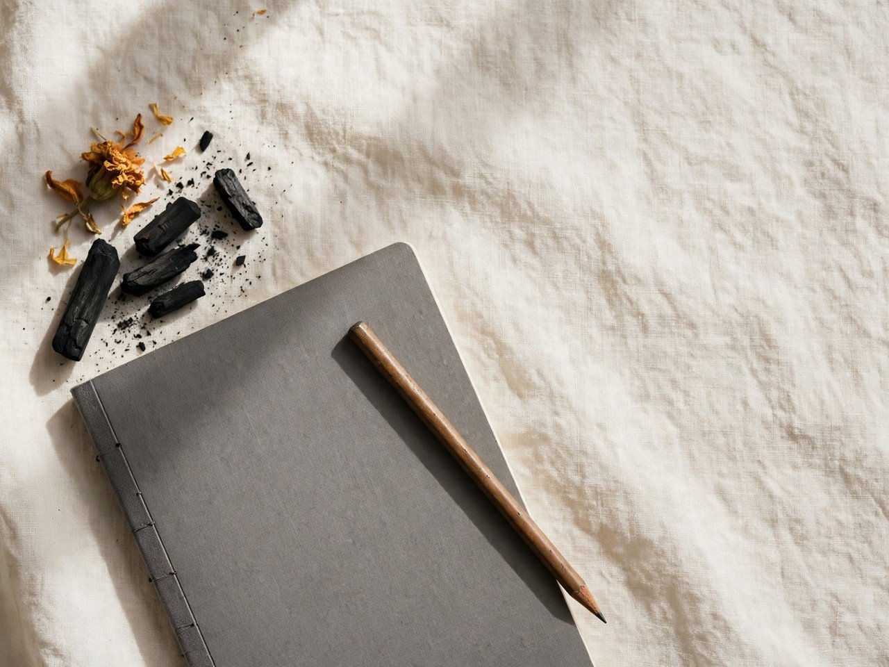 Plain notebook and pencil from above
